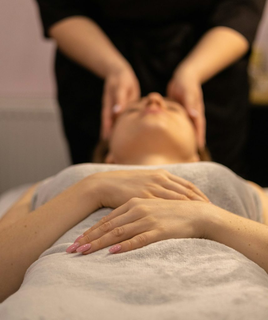 a woman getting a facial massage at a spa